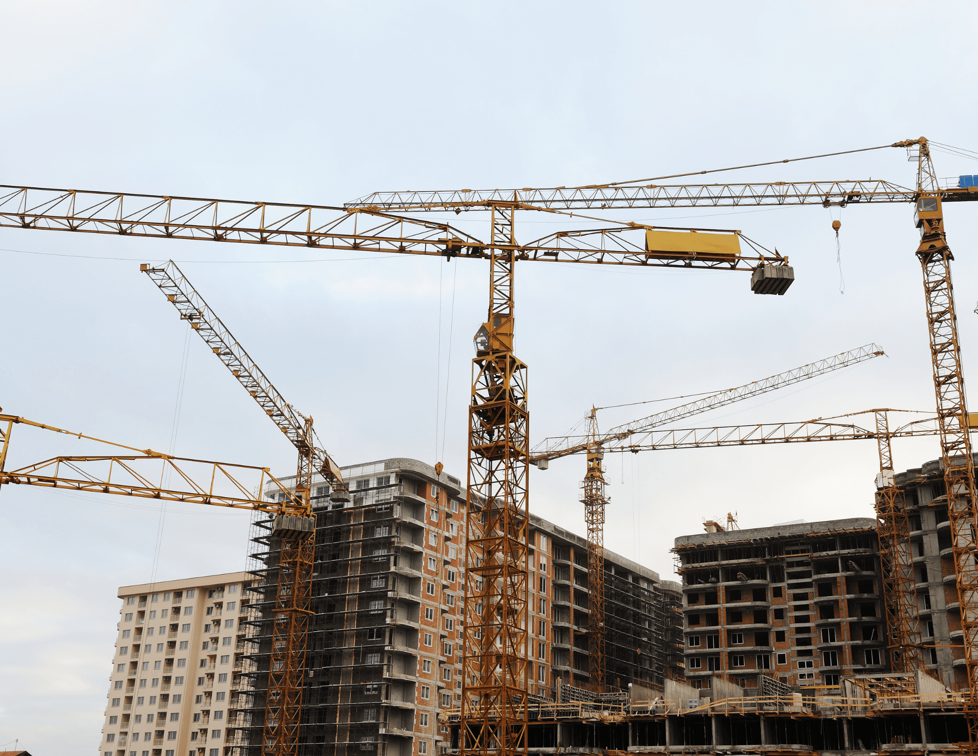 Construction cranes above buildings under development